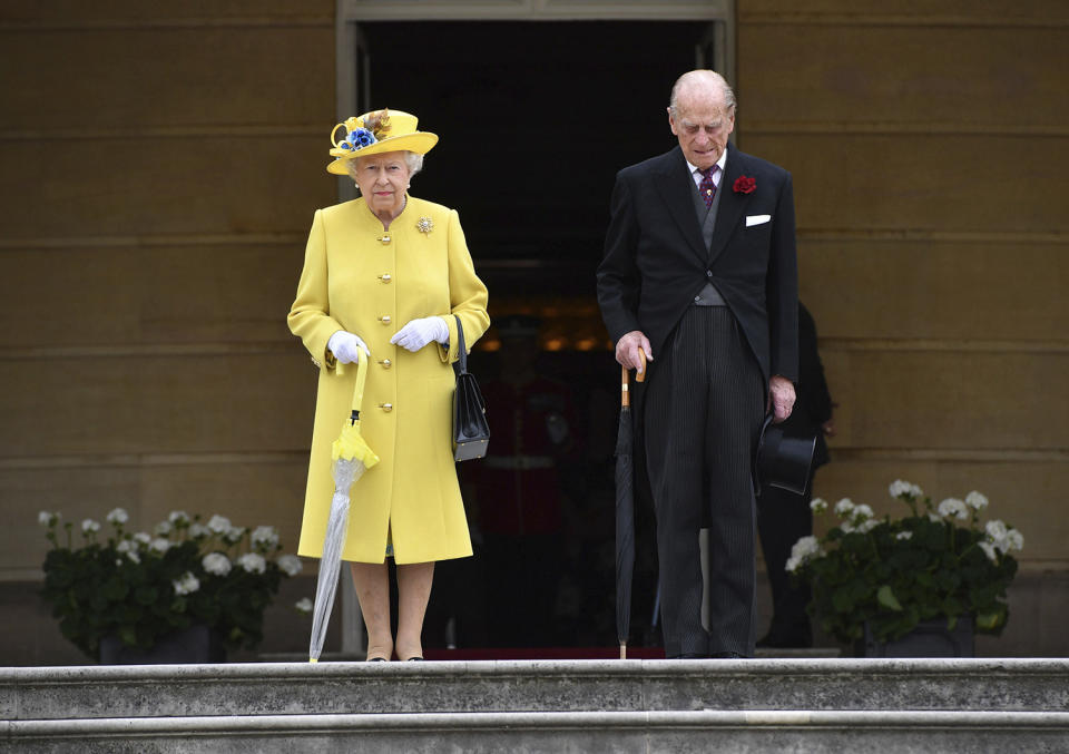 <p>Britain’s Queen Elizabeth and Prince Philip observe a minute’s silence, at the start of a garden party at Buckingham Palace in London, May 23, 2017. The Islamic State group claimed responsibility Tuesday for the suicide attack at an Ariana Grande show that left over 20 people dead and dozens injured. (Photo: Dominic Lipinski/AP) </p>