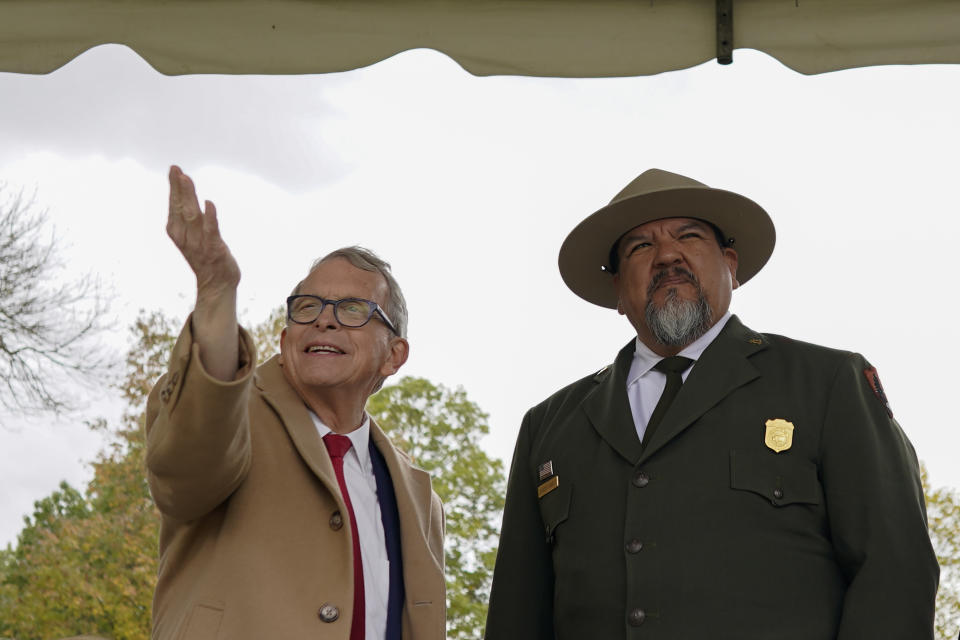 Ohio Gov. Mike DeWine, left, and National Park Service Director Chuck Sams look out over the Mound City Group at Hopewell Culture National Historical Park in Chillicothe, Ohio, Saturday, Oct. 14, 2023, after the Hopewell Ceremonial Earthworks UNESCO World Heritage Inscription Commemoration ceremony. A network of ancient American Indian ceremonial and burial mounds in Ohio noted for their good condition, distinct style and cultural significance, including Hopewell, was added to the list of UNESCO World Heritage sites. (AP Photo/Carolyn Kaster)