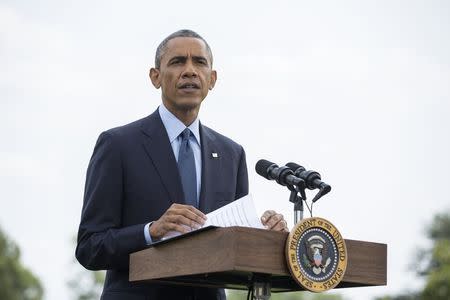 U.S. President Barack Obama speaks to reporters about new sanctions imposed on Russia as he departs the White House in Washington on July 29, 2014. REUTERS/Joshua Roberts