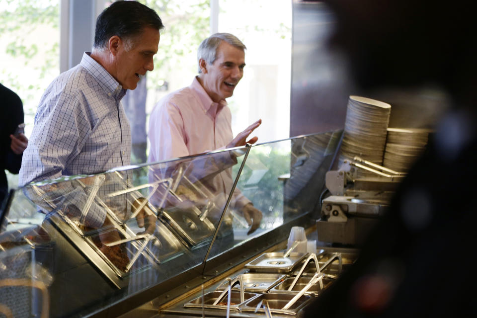 Republican presidential candidate, former Massachusetts Gov. Mitt Romney and Sen. Rob Portman, R-Ohio, place their orders as they make an unscheduled stop at a Chipotle restaurant in Denver, Tuesday, Oct. 2, 2012. (AP Photo/Charles Dharapak)