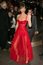 <p>Bella Hadid was follwoing along the same vein in this red Cinderella style dress with a sheer skirt. Photo: Getty </p>