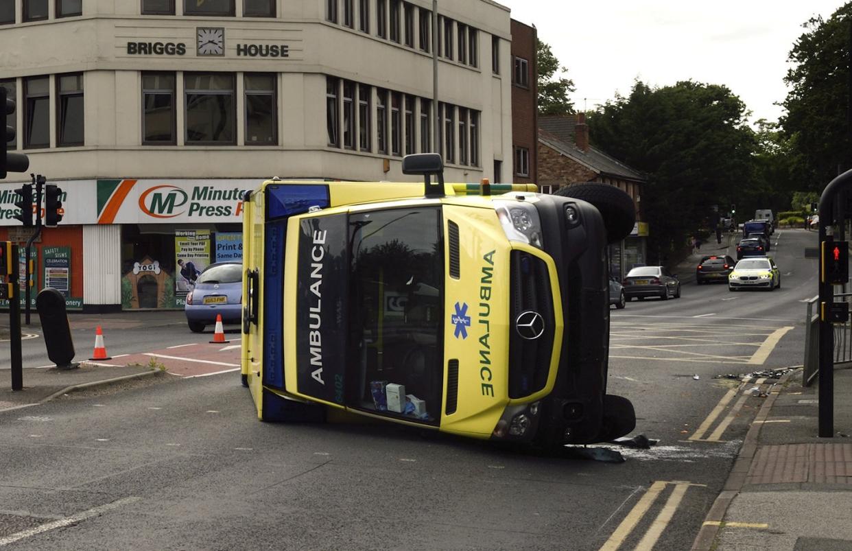 Emergency services are attending a 'serious' crash involving an ambulance and a car in Commercial Road at Ashley Cross which left the ambulance on its side, July 9 2021. See SWNS story SWBRambulance