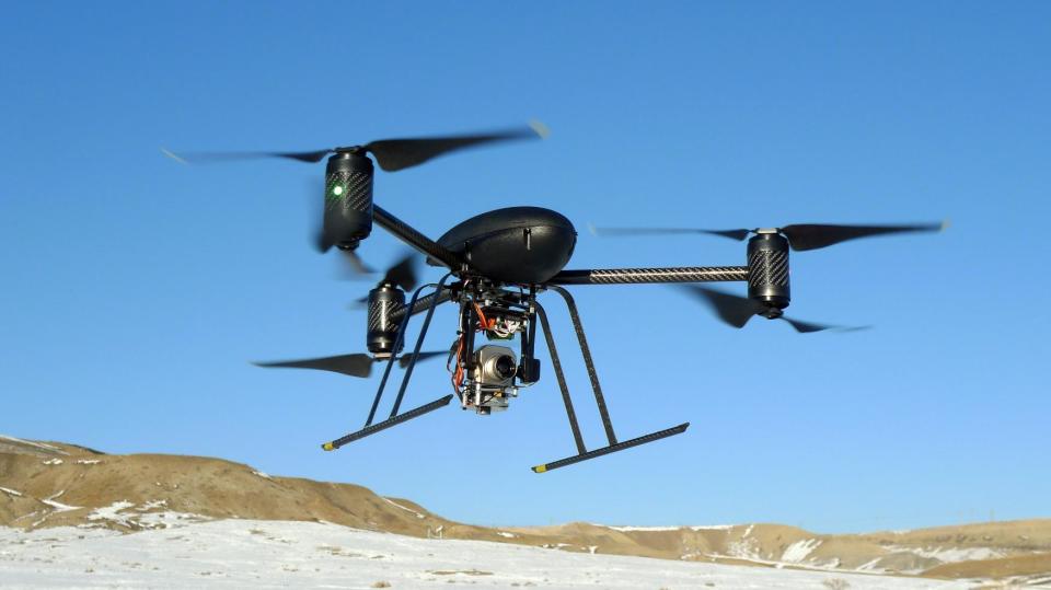 In this Jan. 8, 2009, photo provided by the Mesa County, Colo., Sheriff's Department, a small Draganflyer X6 drone is photographed during a test flight in Mesa County, Colo., with a Forward Looking Infer Red payload. The drone, which was on loan to the sheriff's department from the manufacturer, measures about 36 inches from rotor tip to rotor tip, weights just over two pounds, and has been used for search and rescue mission, to help find suspects, and to identify hot spots after a major fire. (AP Photo/Mesa County Sheriff's Unmanned Operations Team)