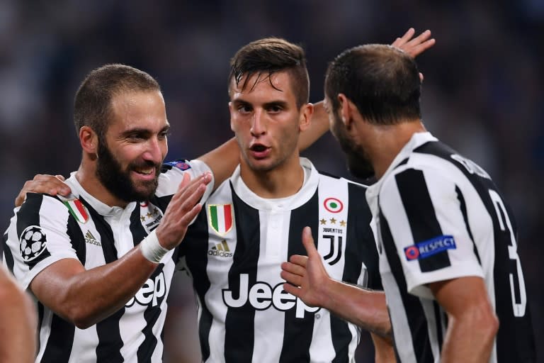 (From L) Juventus' Gonzalo Higuain, Rodrigo Bentancur and Giorgio Chiellini celebrate a goal during their UEFA Champion's League Group D match against Olympiacos, at the Juventus stadium in Turin, on September 27, 2017