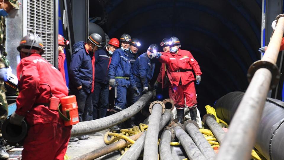 Rescuers work at the site where a coal mine flooded in Hutubi county