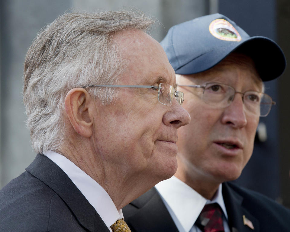 Senate Majority Leader Harry Reid, left, and Interior Secretary Ken Salazar answer questions during a news conference, Friday, Oct. 12, 2012, in Las Vegas, in which he and Salazar announced a plan that sets aside 285,000 acres of public land for the development of large-scale solar power plants. The government is establishing 17 new "solar energy zones" on 285,000 acres in six states: California, Nevada, Arizona, Utah, Colorado and New Mexico. Most of the land,153,627 acres, is in Southern California. (AP Photo/Julie Jacobson).