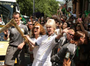 British actresses and torchbearers Joanna Lumley, center right, and Jennifer Saunders, center left, carry the Olympic Flame on the Torch Relay leg between Lambeth and Kensington and Chelsea, in London, Thursday, July 26, 2012. The opening ceremonies for the 2012 Summer Olympics will be held Friday, July 27. (AP Photo/LOCOG,Gareth Fuller)