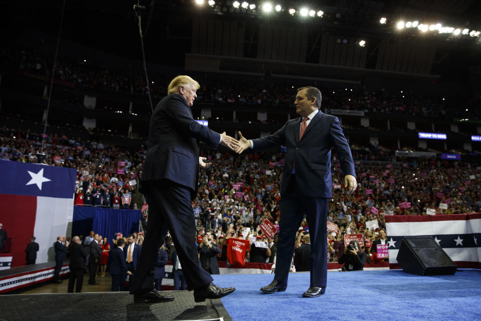 President Donald Trump is greeted by Sen. Ted Cruz, R-Texas, as he arrives for a campaign rally at Houston Toyota Center, Monday, Oct. 22, 2018, in Houston. (AP Photo/Evan Vucci)