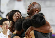 NBA's Los Angeles Lakers Kobe Bryant embraces South Korean students in his basketball clinic for youth in Seoul, South Korea, Thursday, July 14, 2011. Bryant is in Seoul during his five-Asian cities tour. (AP Photo/Lee Jin-man)