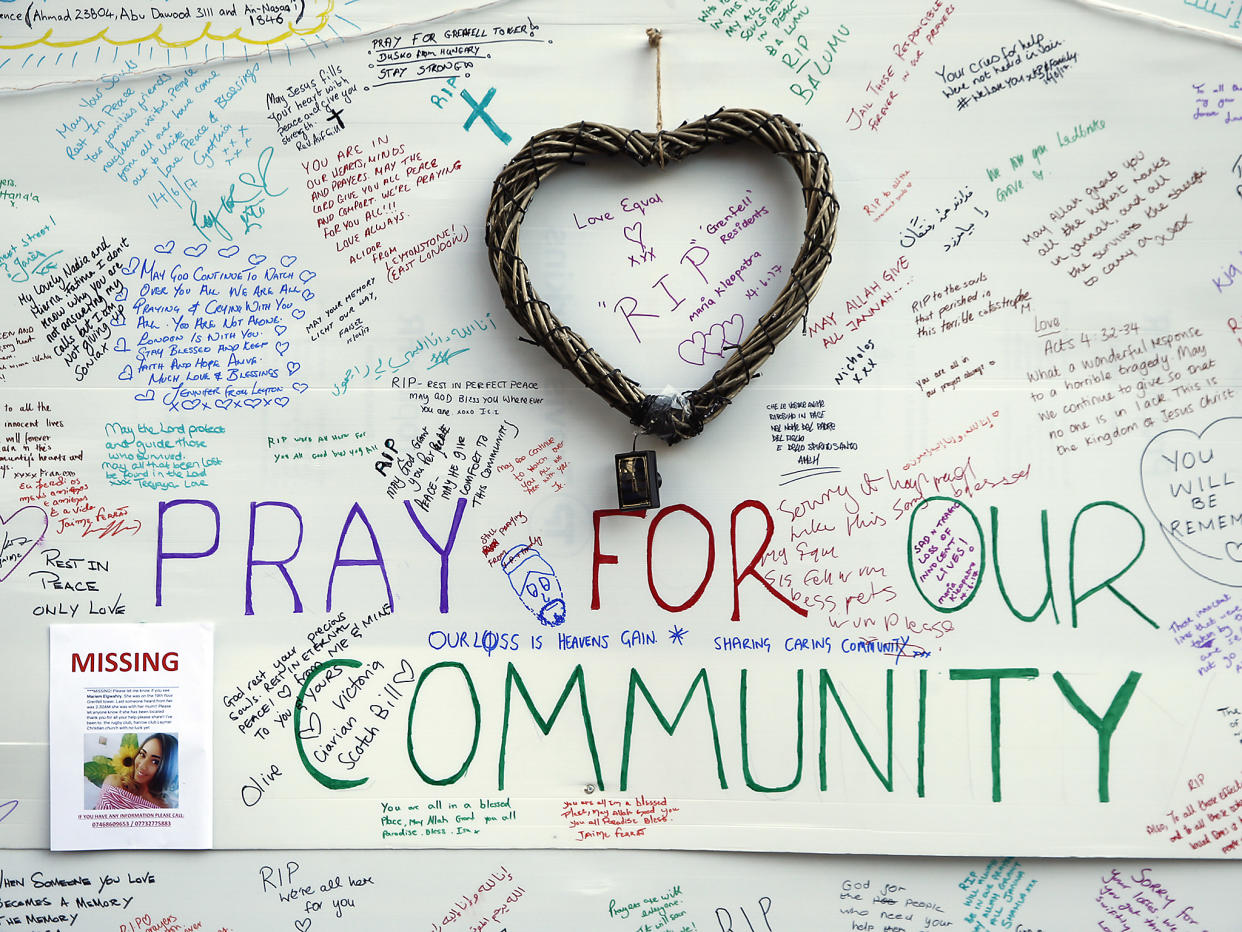 Messages of support for those affected by the massive fire in Grenfell Tower are displayed on a well near the tower in London: AP