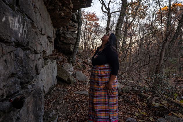 Lauryn examines an ancient rock shelter inside the Delaware Water Gap National Recreation Area, which was used by Lenape ancestors for countless millennia. Recent vandalism has marred the surface of the wall. (Photo: Joe Whittle for HuffPost)