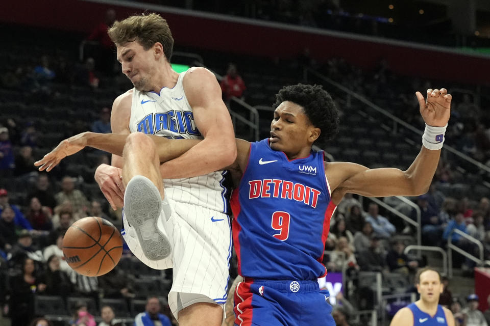 Orlando Magic forward Franz Wagner (22) and Detroit Pistons forward Ausar Thompson (9) get tangled up during the first half of an NBA basketball game, Sunday, Feb. 4, 2024, in Detroit. (AP Photo/Carlos Osorio)