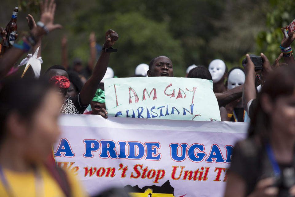 Ugandans take part in the 3rd Annual Lesbian, Gay, Bisexual and Transgender (LGBT) Pride celebrations in Entebbe, Uganda, Saturday, Aug. 9, 2014.  Scores of Ugandan homosexuals and their supporters are holding a gay pride parade on a beach in the lakeside town of Entebbe. The parade is their first public event since a Ugandan court invalidated an anti-gay law that was widely condemned by some Western governments and rights watchdogs. (AP Photo/Rebecca Vassie)