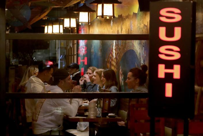 Customers dine inside a sushi restaurant in Long Beach.