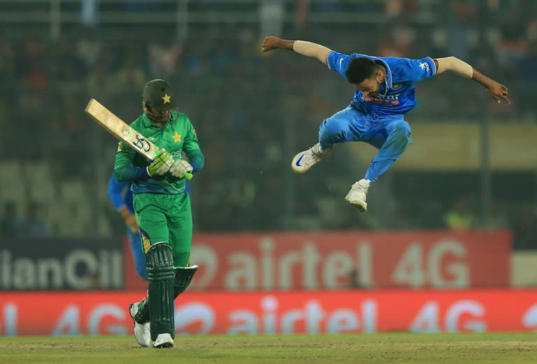 India bowler Hardik Pandya (R) celebrates after the dismissal of the Pakistan batsman Shoaib Malik during a match at the Asia Cup Twenty20 tournament at the Sher-e-Bangla National Cricket Stadium in Dhaka on February 27, 2016