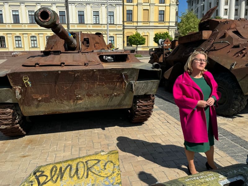 German Minister for Economic Cooperation and Development Svenja Schulze stands in front of Russian tanks captured by Ukraine during her visit to the country ahead of the reconstruction conference for Ukraine, which will take place in Berlin on June 11 and 12. Michael Fischer/dpa