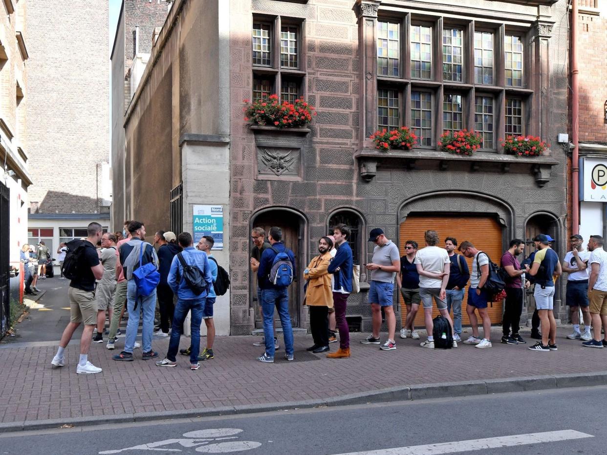 people in street lining up for monkeypox vaccine