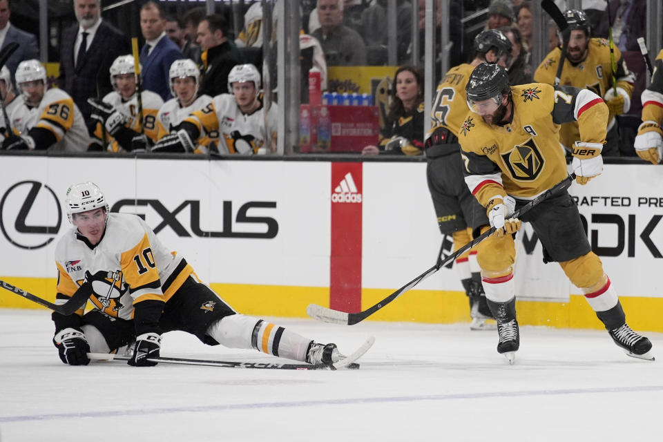 Vegas Golden Knights defenseman Alex Pietrangelo (7) and Pittsburgh Penguins left wing Drew O'Connor (10) vie for the puck during the first period of an NHL hockey game Saturday, Jan. 20, 2024, in Las Vegas. (AP Photo/John Locher)