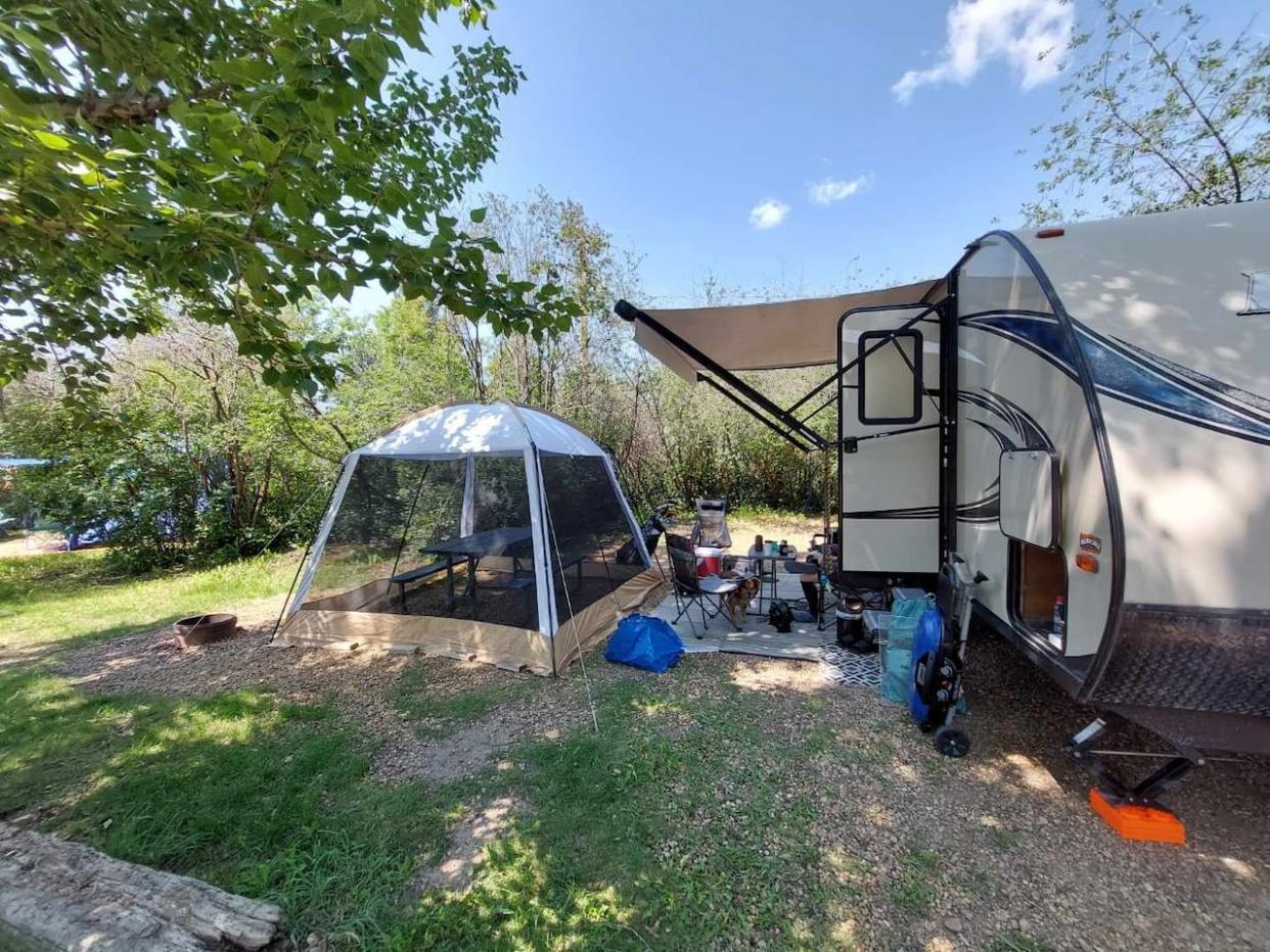 An RV purchased by Alan Hong in 2020 is pictured alongside a tent and camping chairs. Hong says he enjoyed using the RV, but is now ready to spend his vacation time travelling internationally. It's part of a larger trend, with RV sales down around 20 per cent last year. (Submitted by Alan Hong - image credit)