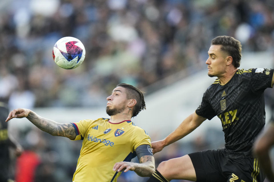 Real Salt Lake forward Cristian Arango, left, heads the ball against Los Angeles FC defender Aaron Long during the first half of an MLS soccer match Sunday, Oct. 1, 2023, in Los Angeles. (AP Photo/Jae C. Hong)