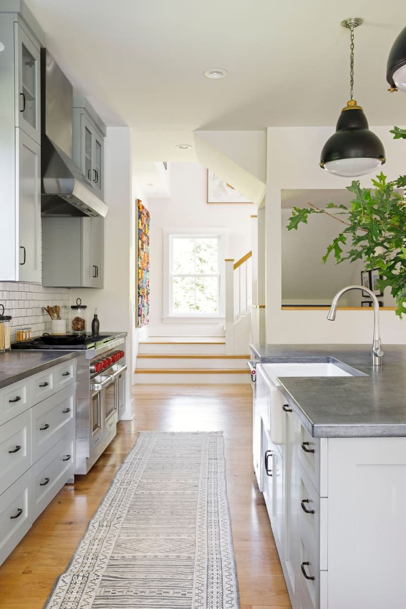 Light kitchen with silver countertops.