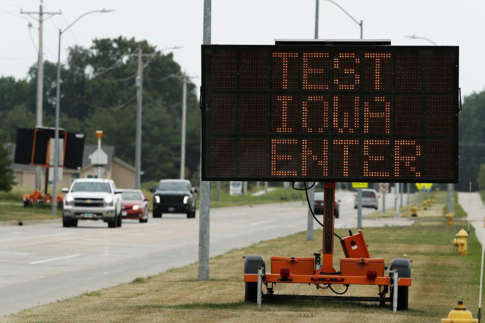 A sign directs traffic to a Test Iowa COVID-19 testing site at Waukee South Middle School, Tuesday, July 14, 2020, in Waukee, Iowa. Iowa state Auditor Rob Sand said Tuesday that a coronavirus testing program brought to the state under a $28 million no-bid contract by Gov. Kim Reynolds on recommendation from actor Ashton Kutcher is violating state law in the indirect way it handles test results data. (AP Photo/Charlie Neibergall)