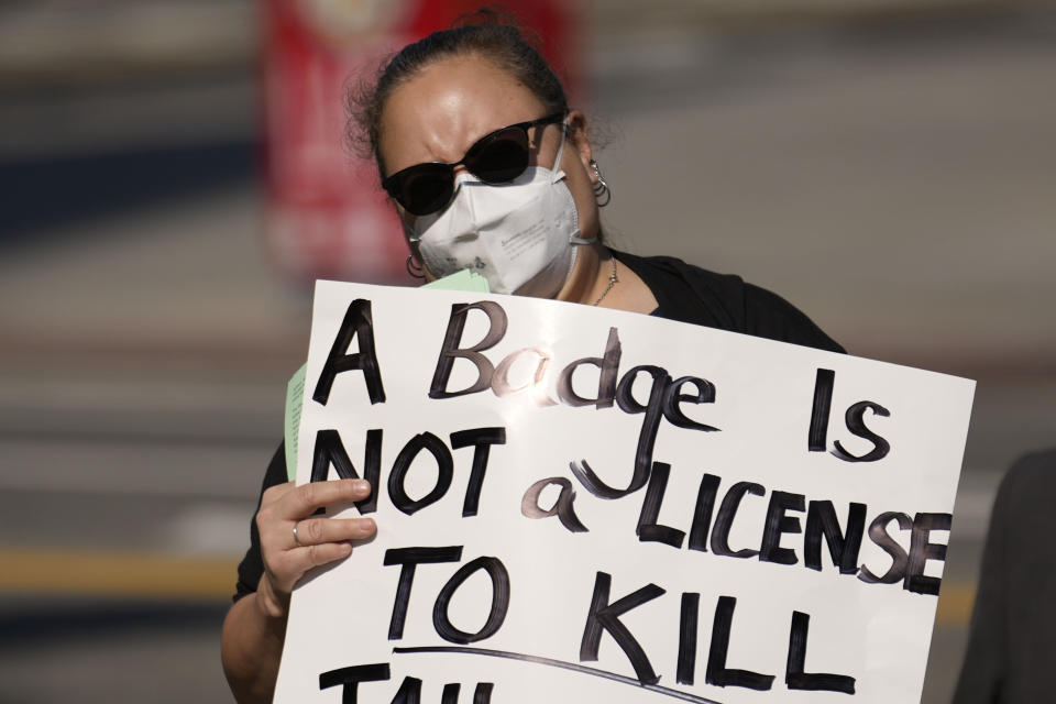 A woman holds a sign Saturday, Jan. 28, 2023, in Los Angeles during a protest over the death of Tyre Nichols, who died after being beaten by Memphis, Tenn., police. (AP Photo/Marcio Jose Sanchez)