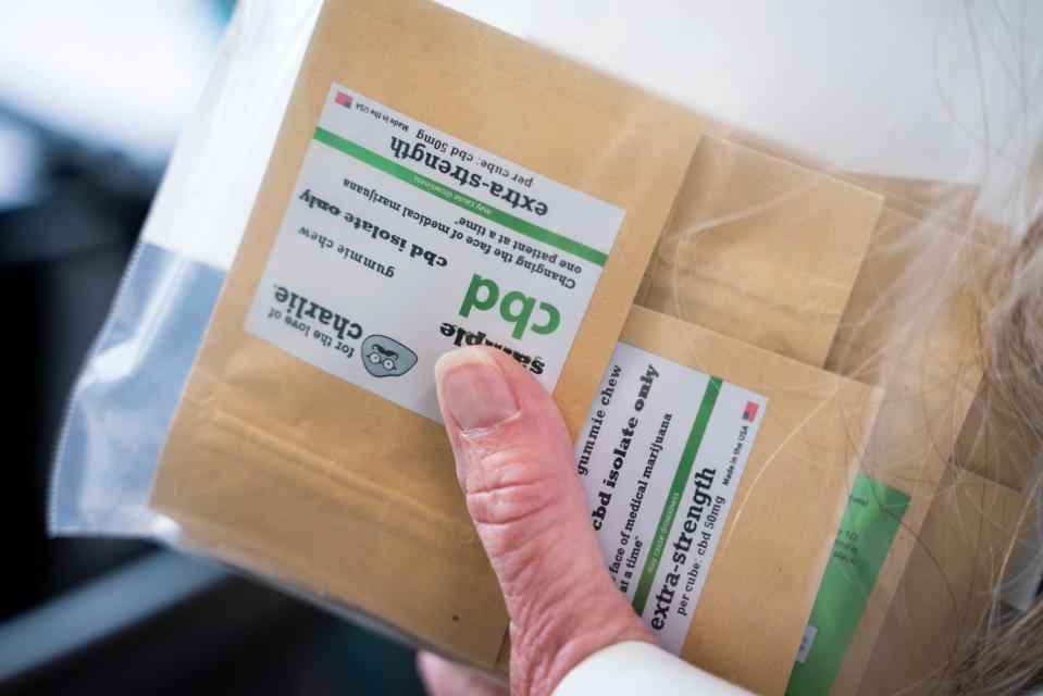 Tucker Jasso, 60, founder of For the Love of Charlie, hands out chewable CBD gummy samples at Baldwin House Senior Living in Hazel Park on Wednesday, August 9, 2023.