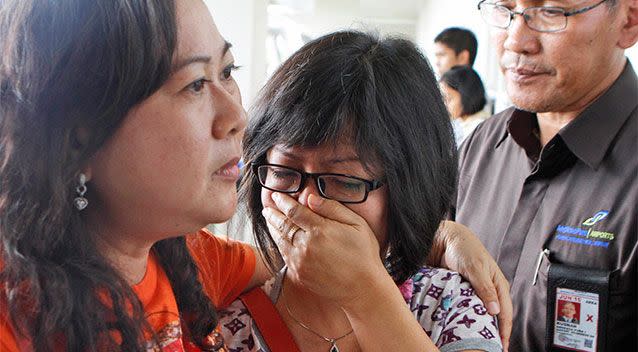 A relative of AirAsia flight QZ8501 passengers weeps as she waits for the latest news on the missing jetliner at Juanda International Airport in Surabaya, East Java, Indonesia. Photo: AP