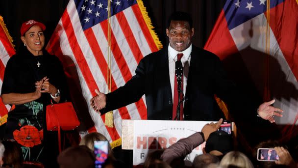 PHOTO: Republican Georgia U.S. Senate candidate Herschel Walker speaks next to his wife Julie during his 2022 U.S. midterm elections night party in Atlanta, on Nov. 8, 2022.   (Jonathan Ernst/Reuters)