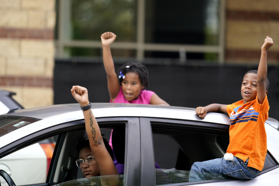 People in cars speak to protesters, Friday, Sept. 25, 2020, in Louisville. Breonna Taylor's family demanded Friday that Kentucky authorities release all body camera footage, police files and the transcripts of the grand jury hearings that led to no charges against police officers who killed the Black woman during a March drug raid at her apartment. (AP Photo/Darron Cummings)