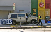 <p>An official walks by a van that plowed into a group of people injuring several on a Los Angeles sidewalk on Sunday, July 30, 2017. A witness to the crash told The Associated Press the van jumped a curb and careened into a group of people eating outside The Fish Spot restaurant in the city’s Mid-Wilshire neighborhood. (AP Photo/Damian Dovarganes) </p>