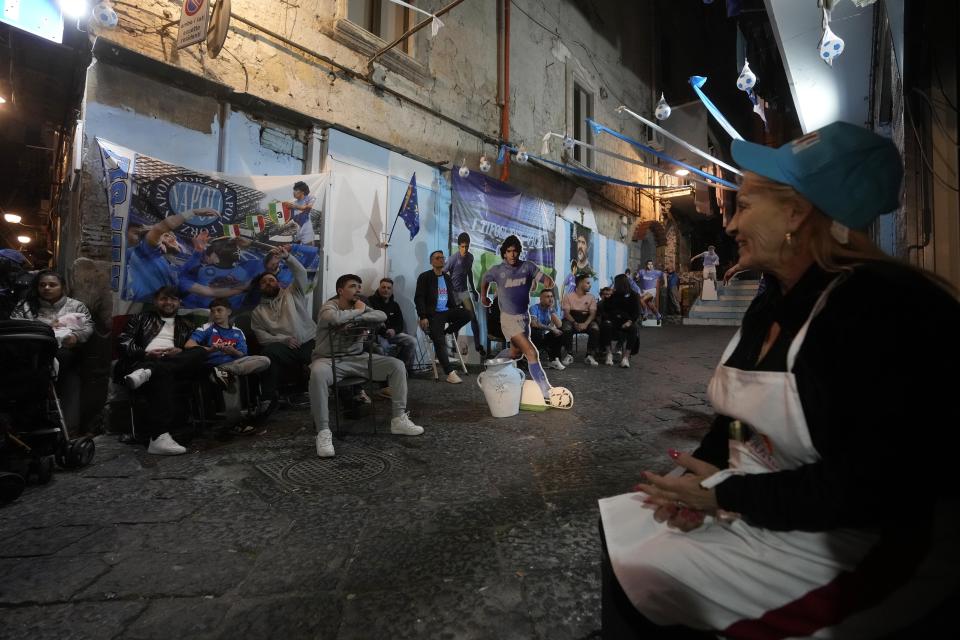 Napoli fans watch television live broadcasting Udinese Napoli Serie A soccer match, in Naples, Italy, Thursday, May 4, 2023. For the third time in five days, Napoli fans are hoping and preparing to celebrate the Italian league soccer title. (AP Photo/Andrew Medichini)