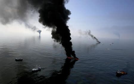 Smoke billows from a controlled burn of spilled oil off the Louisiana coast in the Gulf of Mexico coast line June 13, 2010. REUTERS/Sean Gardner