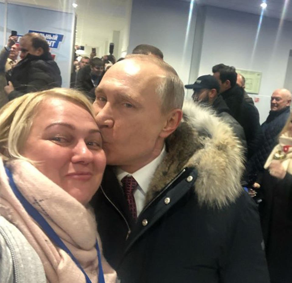 Vladimir Putin kisses Larisa Sergukhina while she takes a selfie with him. (CEN)