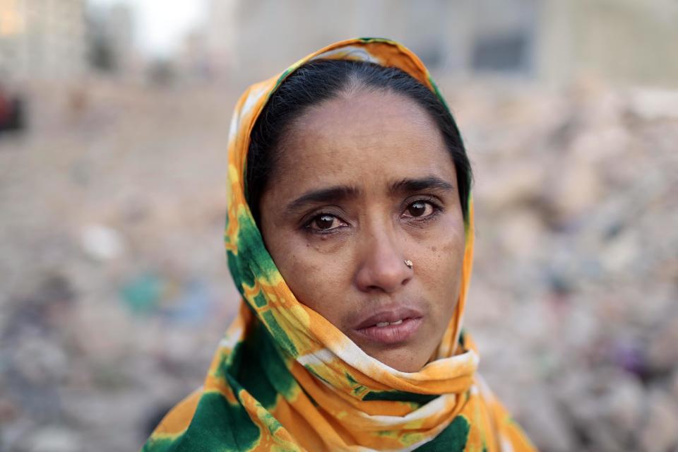 A Bangladeshi woman who lost her son in the Rana Plaza building collapse cries at the site of the accident, the worst in the history of the garment industry, on the eve of the tragedy in Savar, near Dhaka, Bangladesh, Wednesday, April 23, 2014. More than 1,100 people were killed when the illegally constructed, 8-storey building collapsed on April 24, 2013, in a heap along with thousands of workers in the five garment factories in the building. (AP Photo/A.M. Ahad)