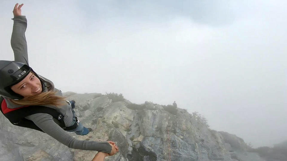 These friends filmed themselves freefalling backwards from a cliff - while holding hands. Josephine Eve, 28, and Niclas Strohmeier, 23, performed the stunt at the BASE jumping hotspot of Monte Brento, Italy. They fall backwards into the dense mist below before separating in the air and landing safely.