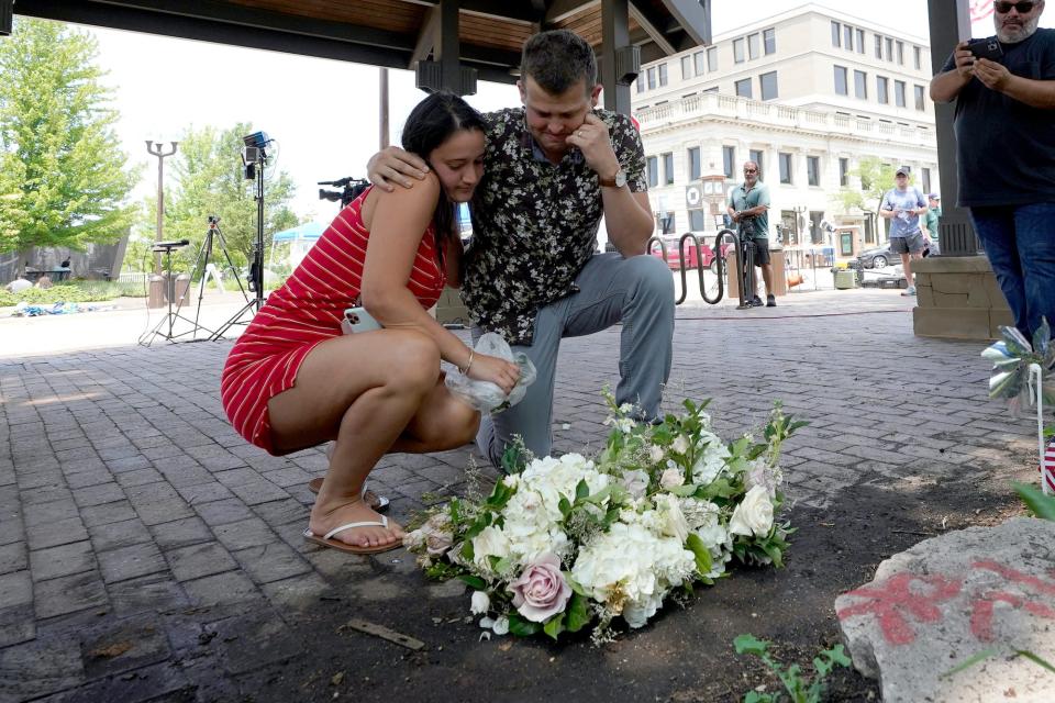 Brooke and Matt Strauss, who were married Sunday, pause after leaving their wedding bouquets in downtown Highland Park on Tuesday, July 5, 2022