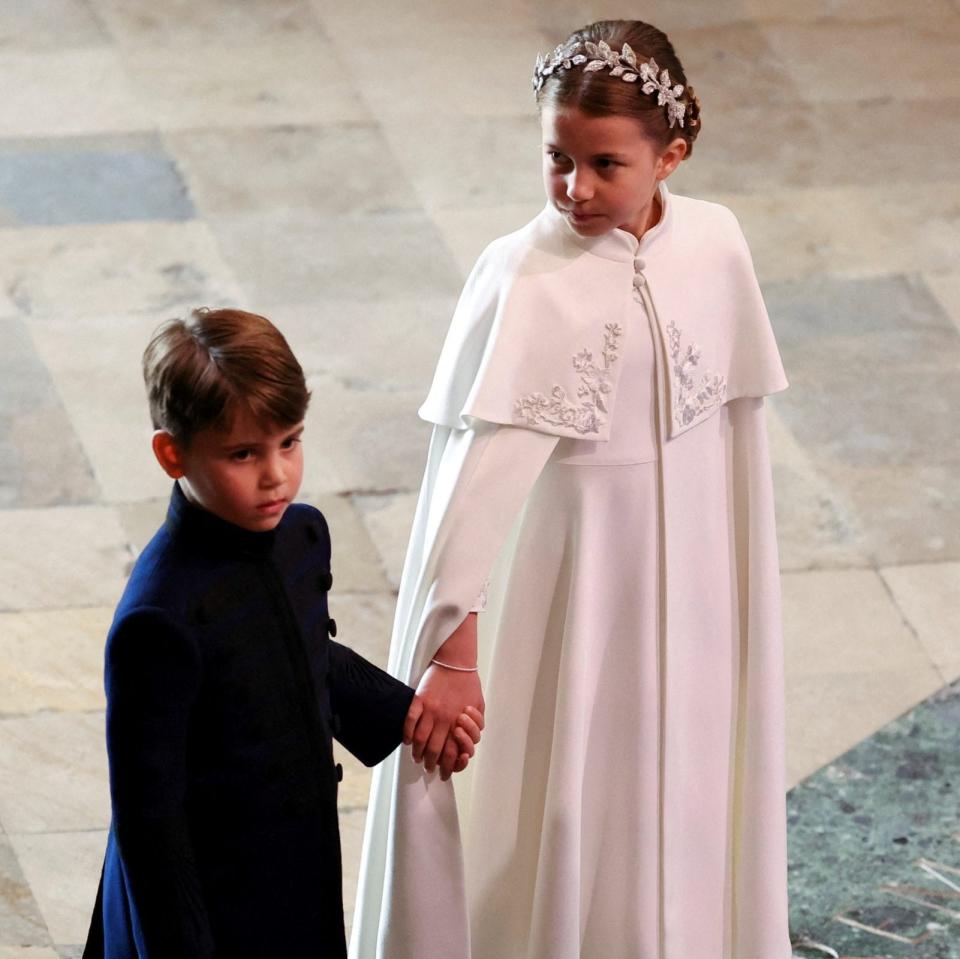 Prince George and Princess Charlotte hold hands before the ceremony - PHIL NOBLE