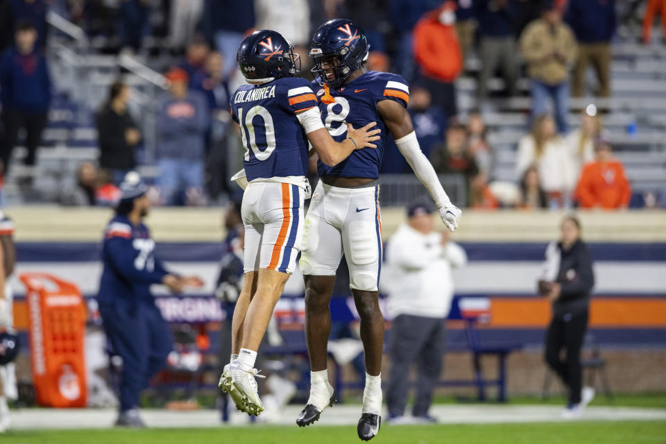 Virginia quarterback Anthony Colandrea (10) celebrates with wide receiver Malachi Fields (8) as time expires to defeat Duke in an NCAA college football game Saturday, Nov. 18, 2023, in Charlottesville, Va. (AP Photo/Mike Caudill)