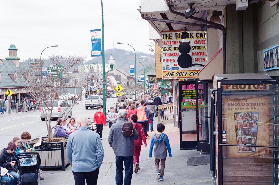 Tourists walk through downtown Gatlinburg, Tennessee. Only about one-quarter of the park’s more than 12 million annual visitors stop at a visitor center. Many plan their Smokies adventure based on conversations with the hotel clerks, servers, and retail workers they meet in town.