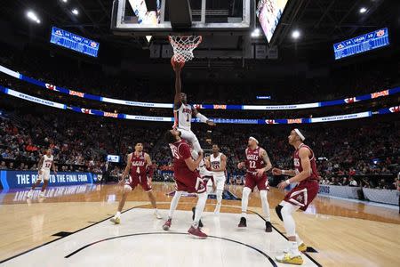 Mar 21, 2019; Salt Lake City, UT, USA; Auburn Tigers guard Jared Harper (1) goes up for a shot and collides with New Mexico State Aggies forward Johnny McCants (35) during the first half in the first round of the 2019 NCAA Tournament at Vivint Smart Home Arena. Mandatory Credit: Kirby Lee-USA TODAY Sports