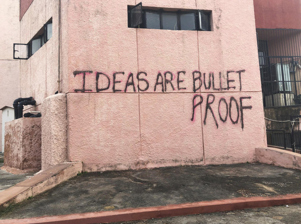 In this Wednesday, Dec. 18, 2019 photo, a graffiti covers the wall of a building at Jamia Millia Islamia University in New Delhi, India. Students of this New Delhi university have turned the campus' sandstone walls into a canvas of discontent. The spray-painted slogans and symbols reflect their opposition to a new law that provides a path to citizenship for religious groups from neighboring countries except Muslims. (AP Photo/Sheikh Saaliq)