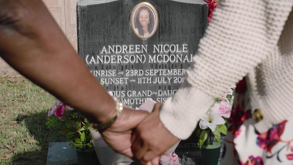 Maureen Smith and Cindy Johnson hold hands in front of Andreen McDonald's grave. / Credit: CBS News