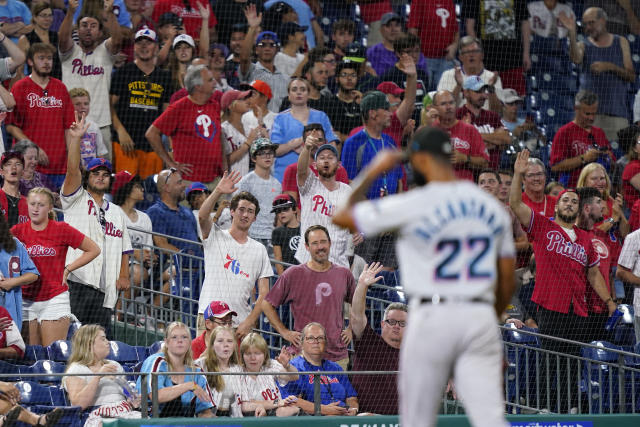 Fans wave to Miami Marlins pitcher Sandy Alcantara after he was pulled during the eighth inning of a baseball game against the Philadelphia Phillies, Wednesday, Aug. 10, 2022, in Philadelphia. (AP Photo/Matt Slocum)