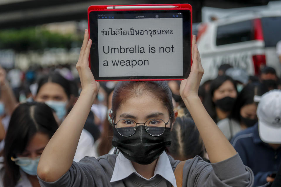 A young pro-democracy activist displays a message during a demonstration at Kaset intersection, suburbs of Bangkok, Thailand, Monday, Oct. 19, 2020. Thai authorities worked Monday to stem a growing tide of protests calling for the prime minister to resign by threatening to censor news coverage, raiding a publishing house and attempting to block the Telegram messaging app used by demonstrators. (AP Photo/Sakchai Lalit)