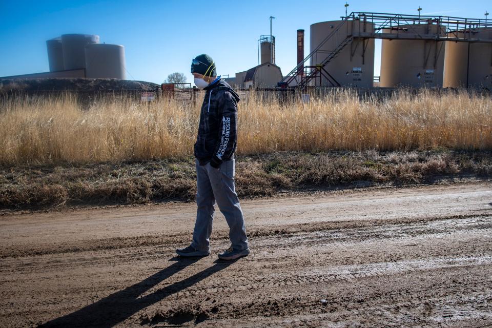 Larimer County resident Von Bortz walks next to a Prospect Energy LLC oil and gas facility on North Larimer County Road 13 north of Fort Collins in November.