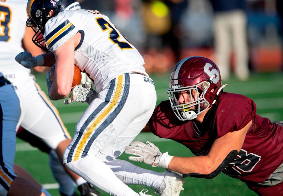 State College’s Stephen Scourtis dives to stop Mt. Lebanon’s ball carrier during the PIAA class 6A semifinal game on Saturday, Dec. 4, 2021 at Mansion Park. Mt. Lebanon won, 49-28.