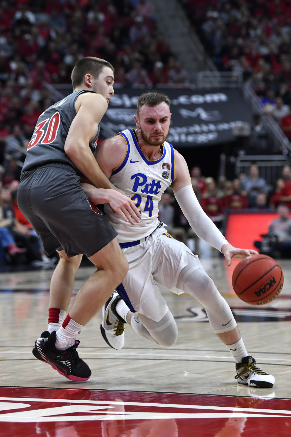 Pittsburgh guard Ryan Murphy (24) fights to get around the defense of Louisville guard Ryan McMahon (30) during the first half of an NCAA college basketball game in Louisville, Ky., Friday, Dec. 6, 2019. (AP Photo/Timothy D. Easley)