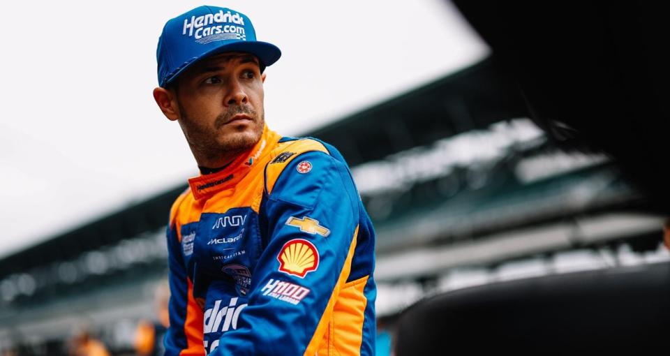 NASCAR champion Kyle Larson looks on from pit wall during Indianapolis 500 practice.